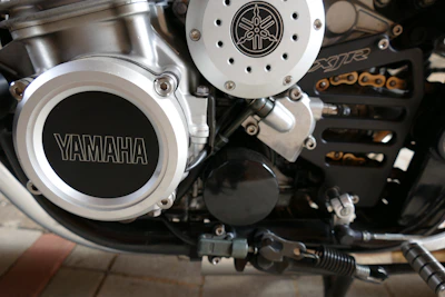 Close-up of a Yamaha bike's detailed engine and logo, showcasing craftsmanship.