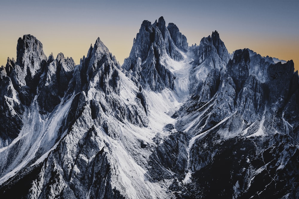 a snowy mountain with a cloudy sky