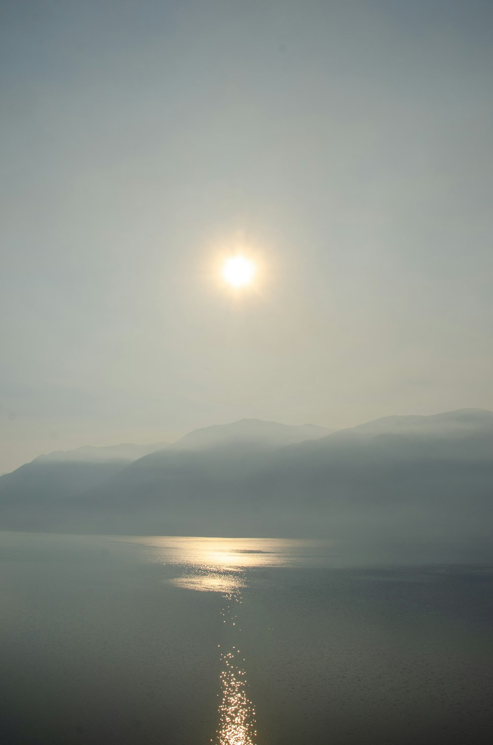 a body of water with a mountain in the background