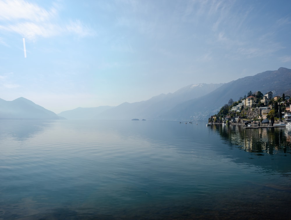 a large body of water with a mountain in the background