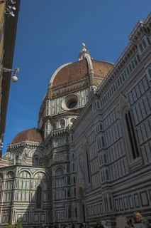 The majestic façade of Duomo di Milano under a bright blue sky.