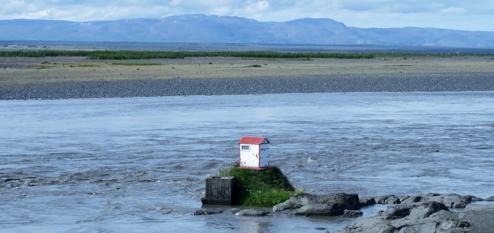 a small house on a small island in a body of water