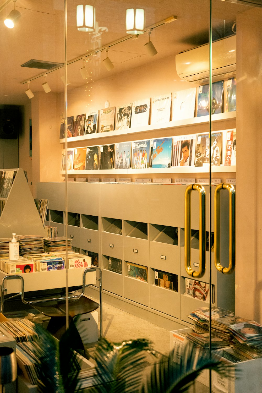 a room with shelves and a glass door with a glass window