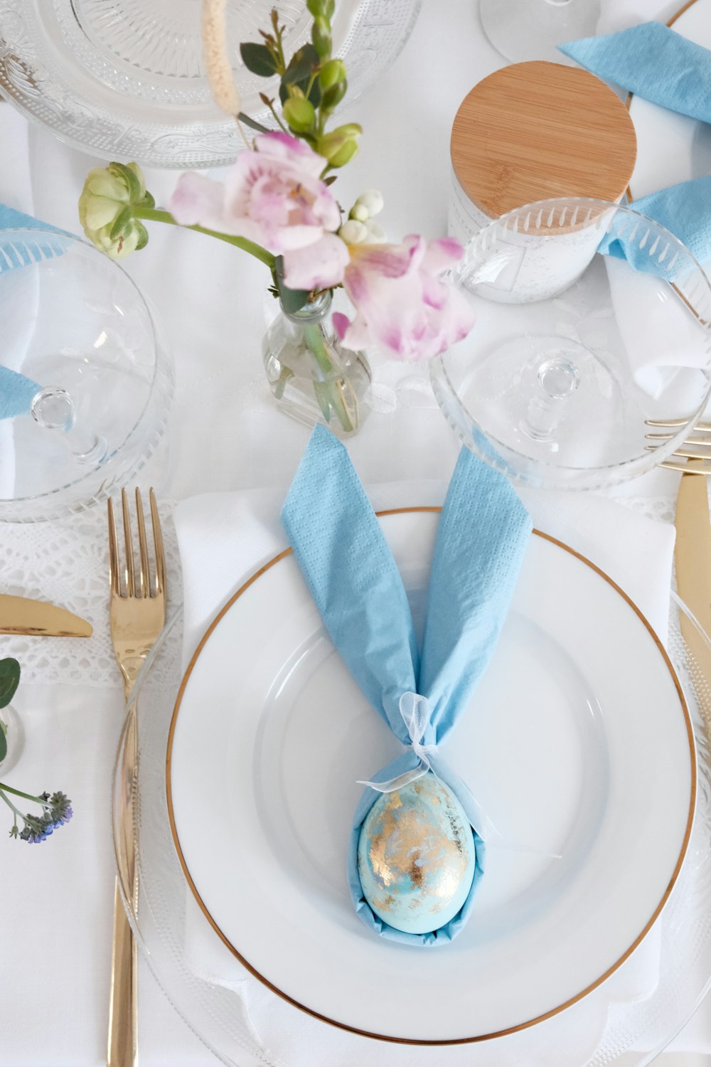 a plate with a blue napkin and flowers on it