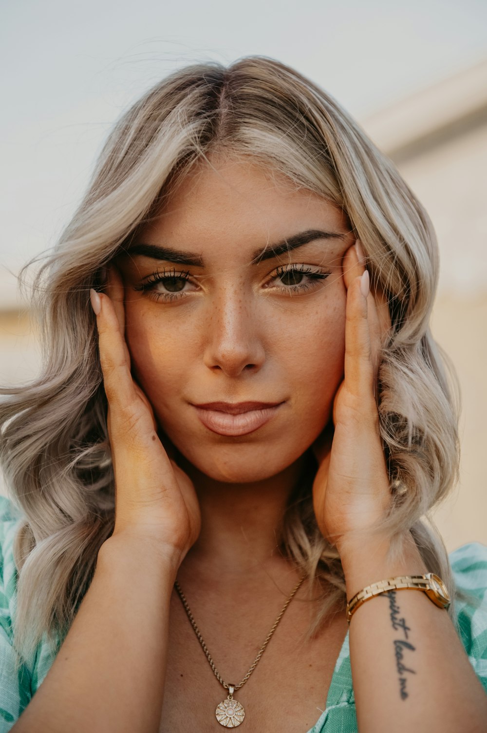 a woman with her hands on her face