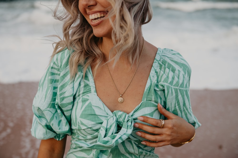 a woman smiling and pointing