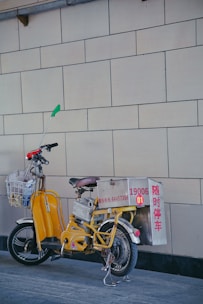 a bicycle parked next to a wall