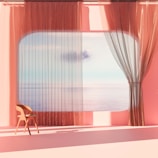 A bright hotel room with minimalist furniture and a large window overlooking the ocean.