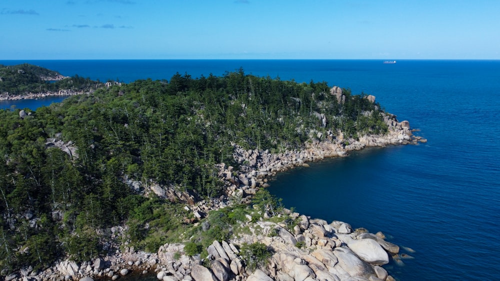 a rocky cliff next to a body of water