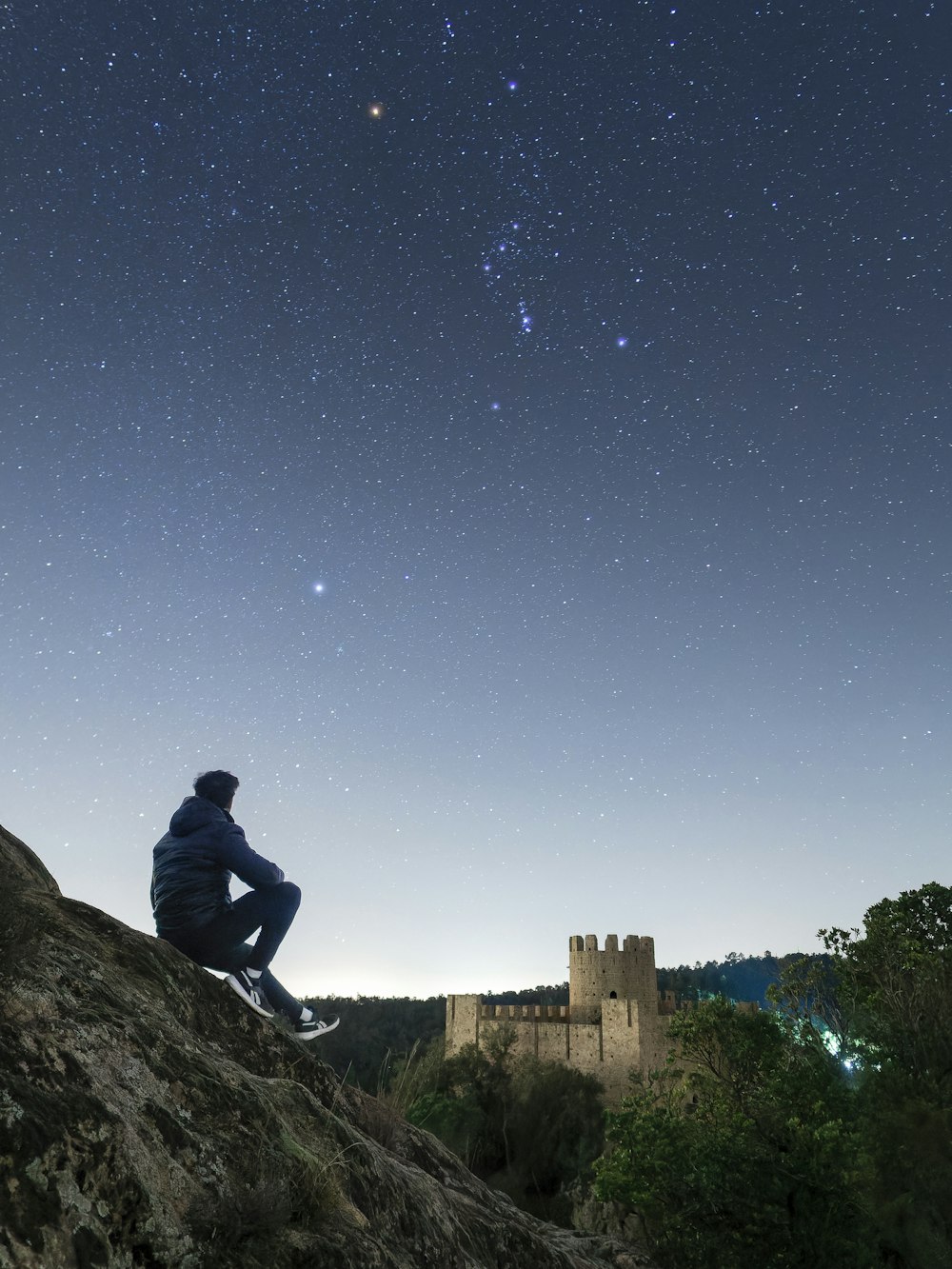 a person sitting on a rock