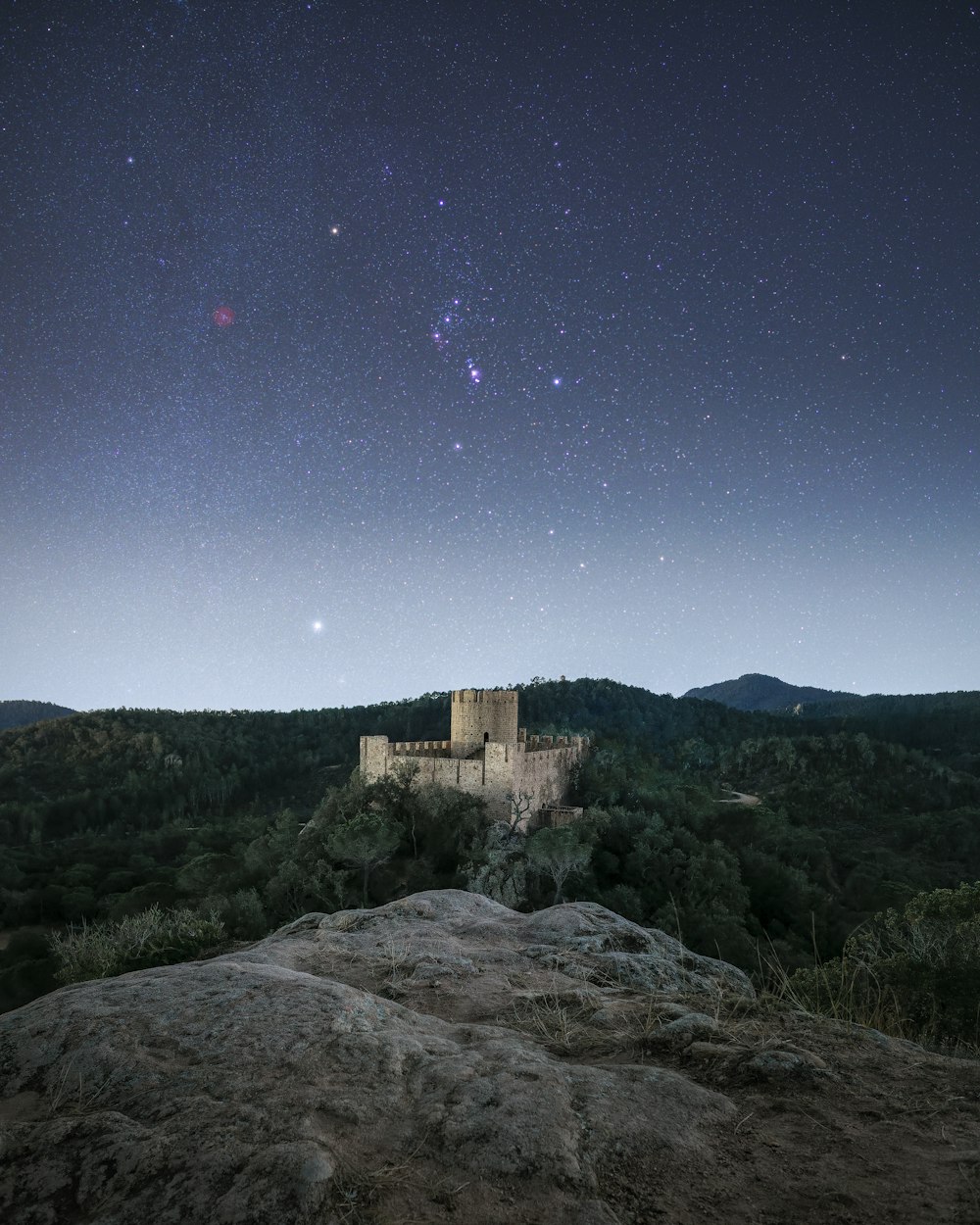 a stone castle on a hill