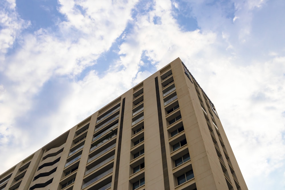 a tall building with a cloudy sky