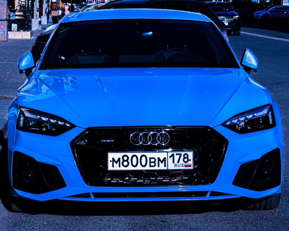 a blue car with a white license plate