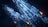 A futuristic spacecraft with intricate details and angular designs, featuring illuminated sections and control panels. The craft is set against a dark, cloudy background, giving a sense of deep space.