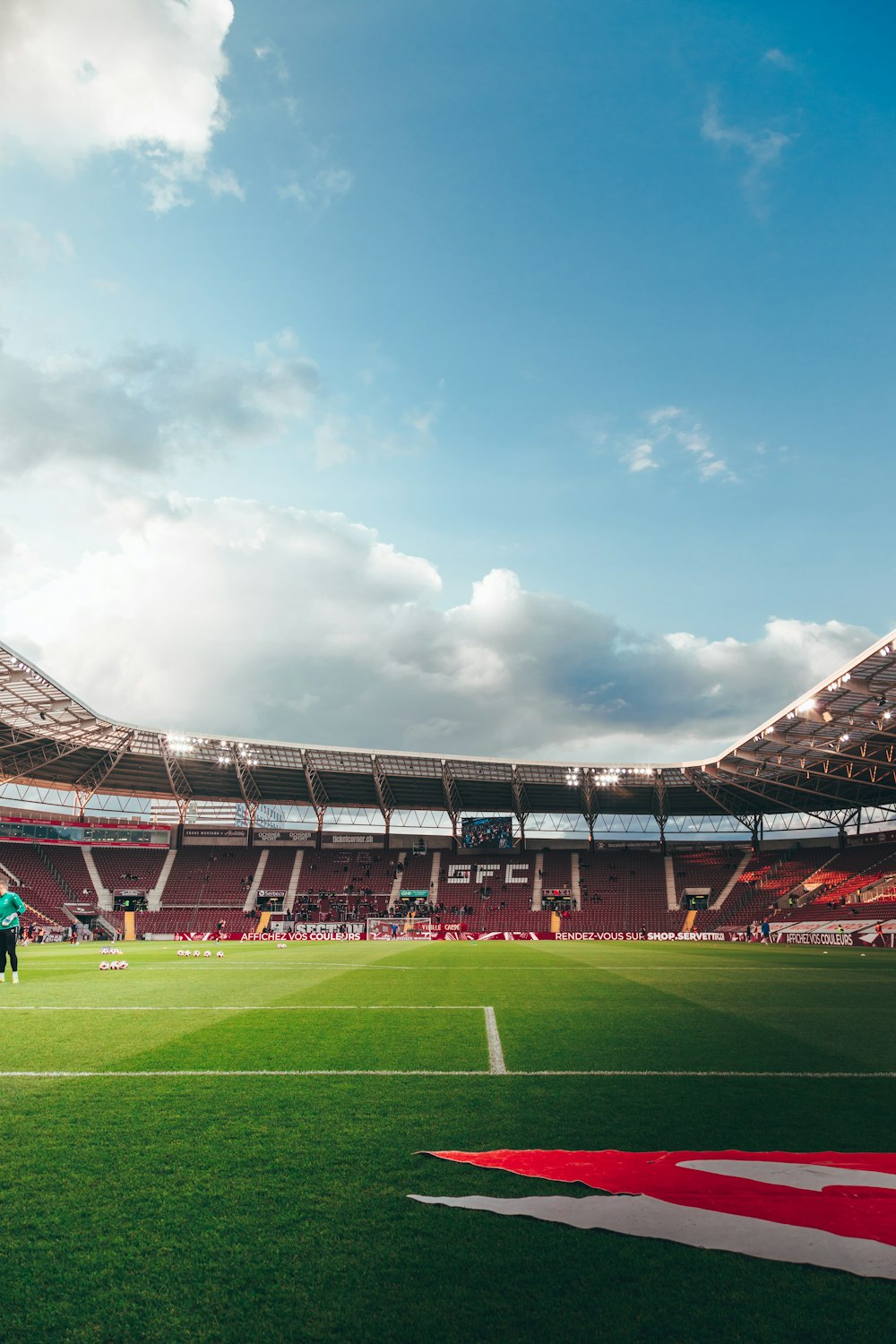 a sports field with a crowd in the background