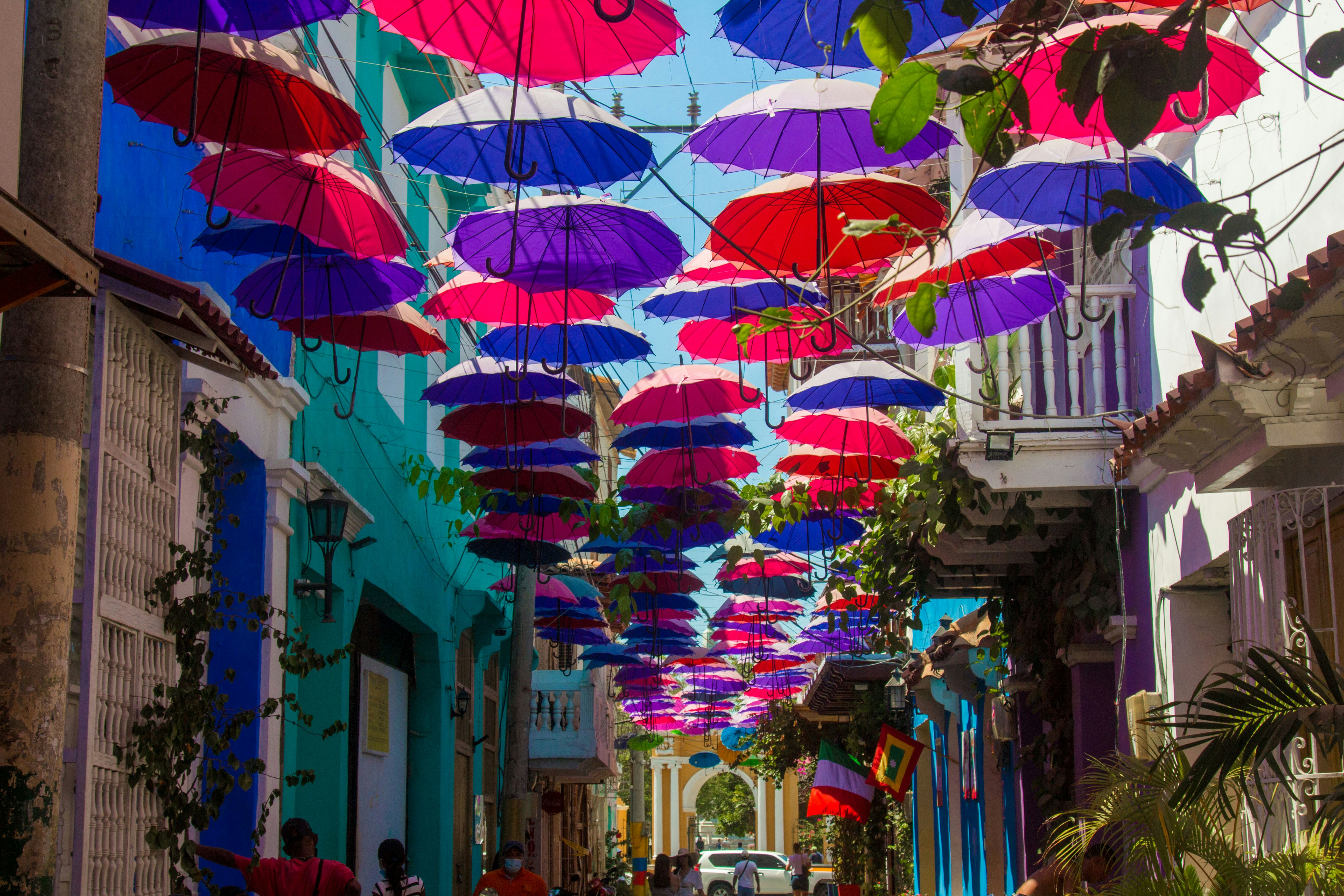 Colored umbrellas strung above a street in Getsemaní, Cartagena