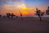 A serene desert landscape at sunset, highlighting the natural beauty of Morocco.