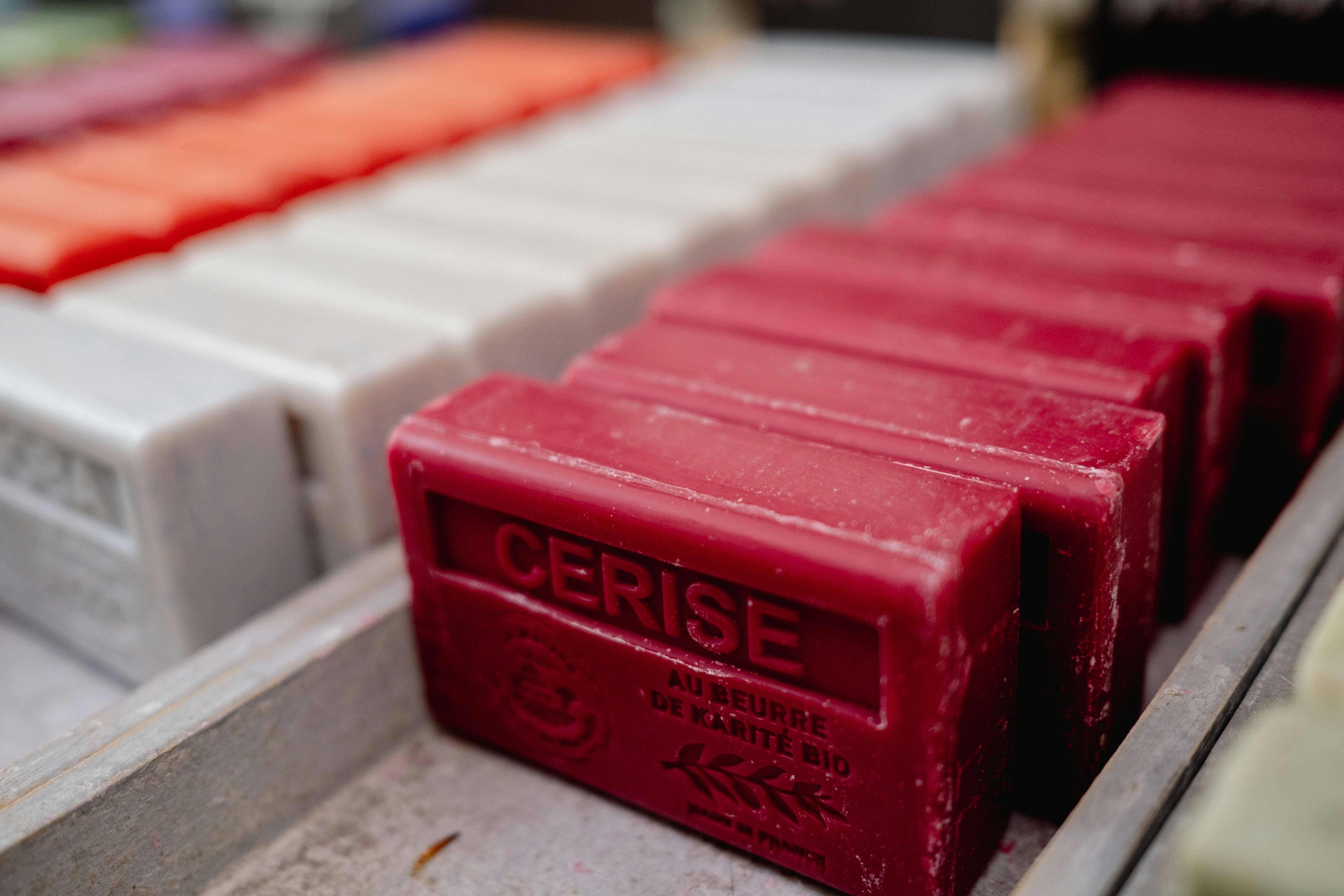 Red and white antibacterial soap bars on clean white bathroom shelf