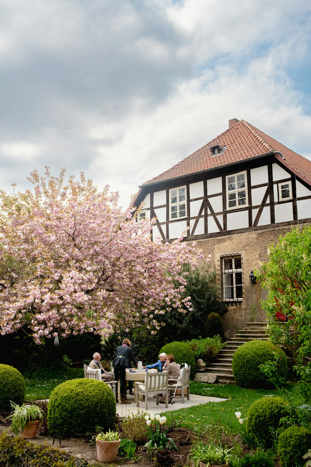 a group of people sitting outside a house