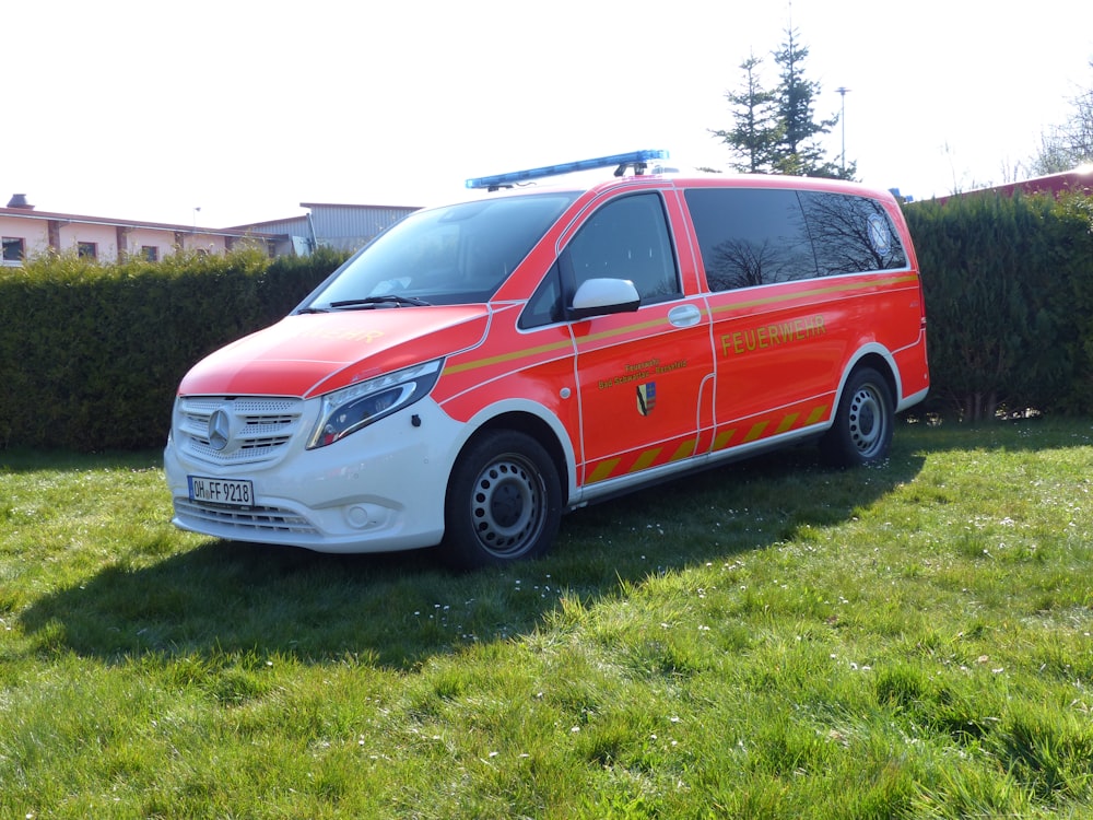 a red van parked in a yard