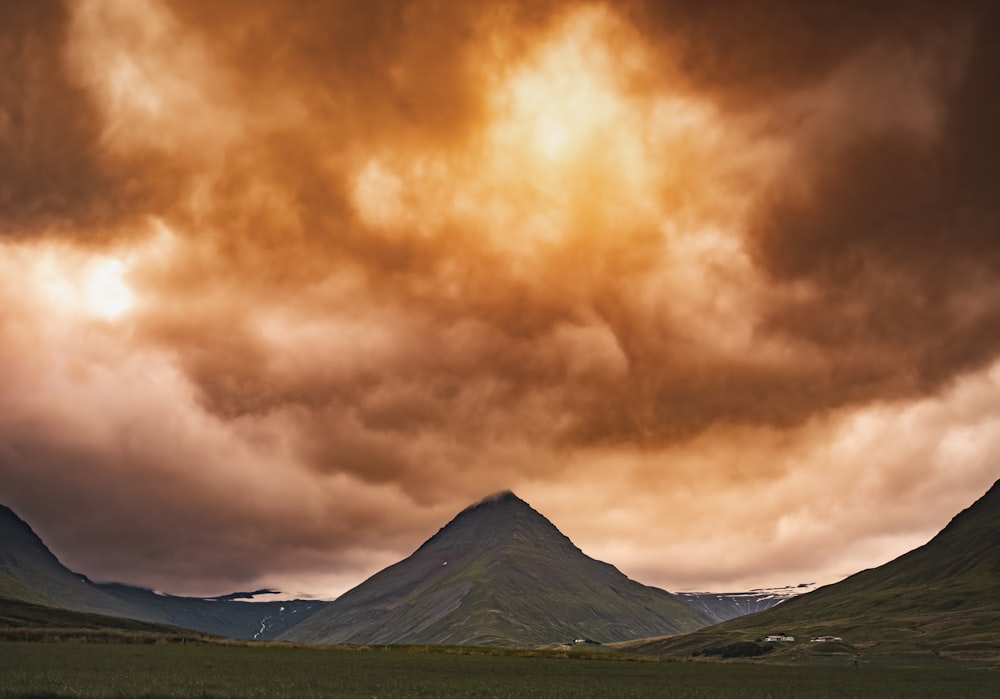 a mountain with a cloudy sky