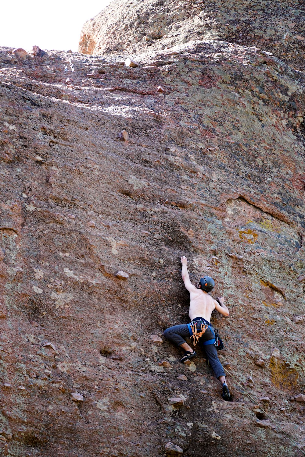 a man climbing a rocky mountain