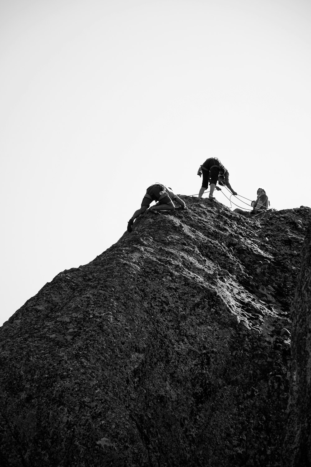 a group of people climbing a mountain