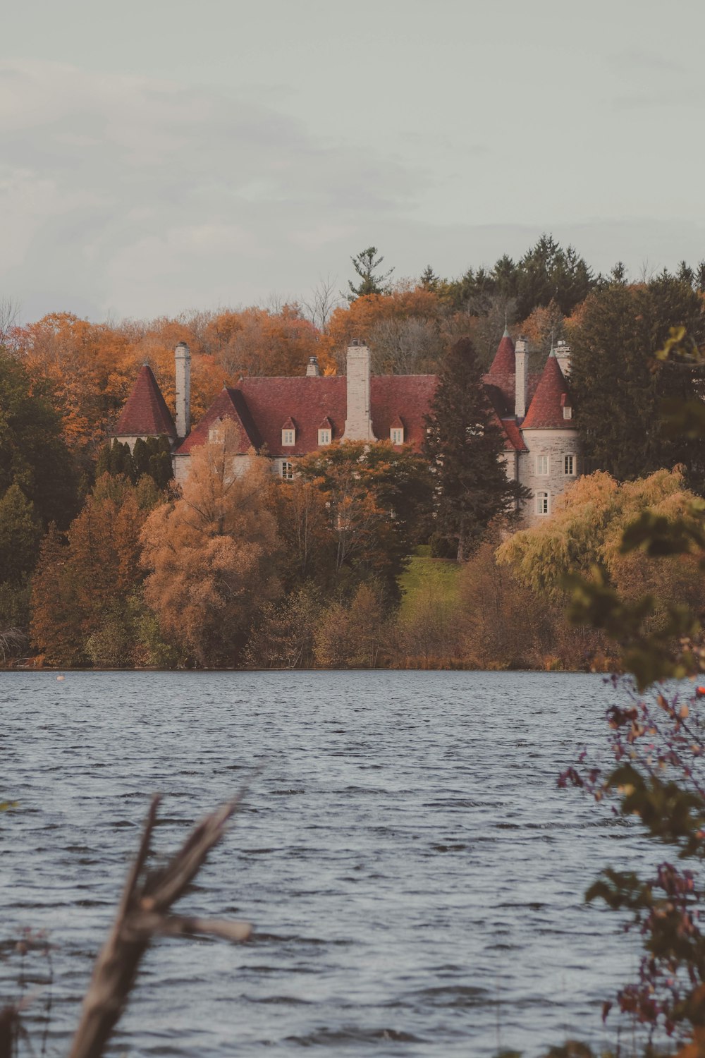 a house on a hill by a lake