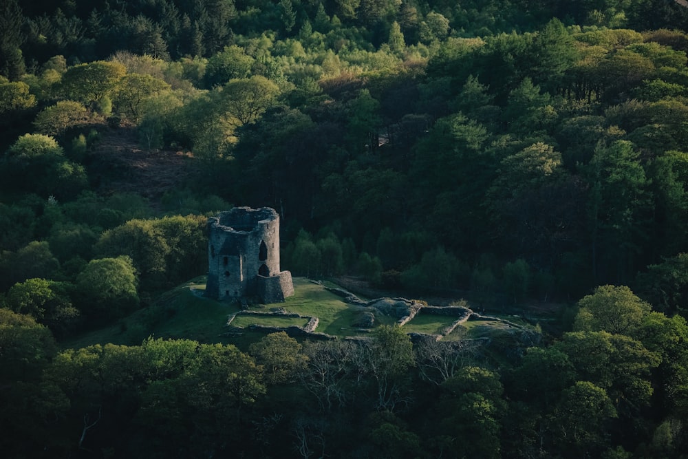 a stone structure surrounded by trees