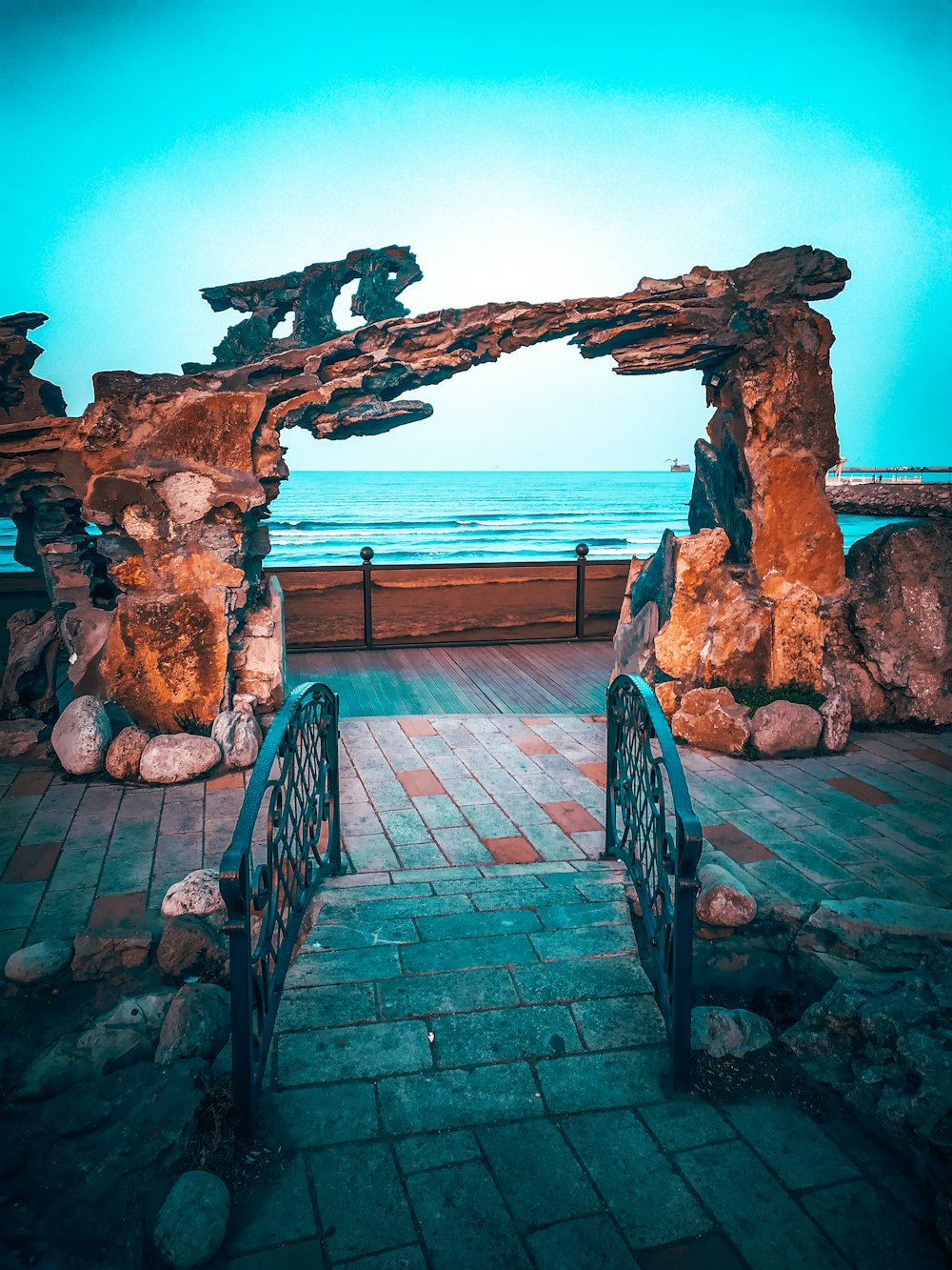 a bench sits in front of a large arch