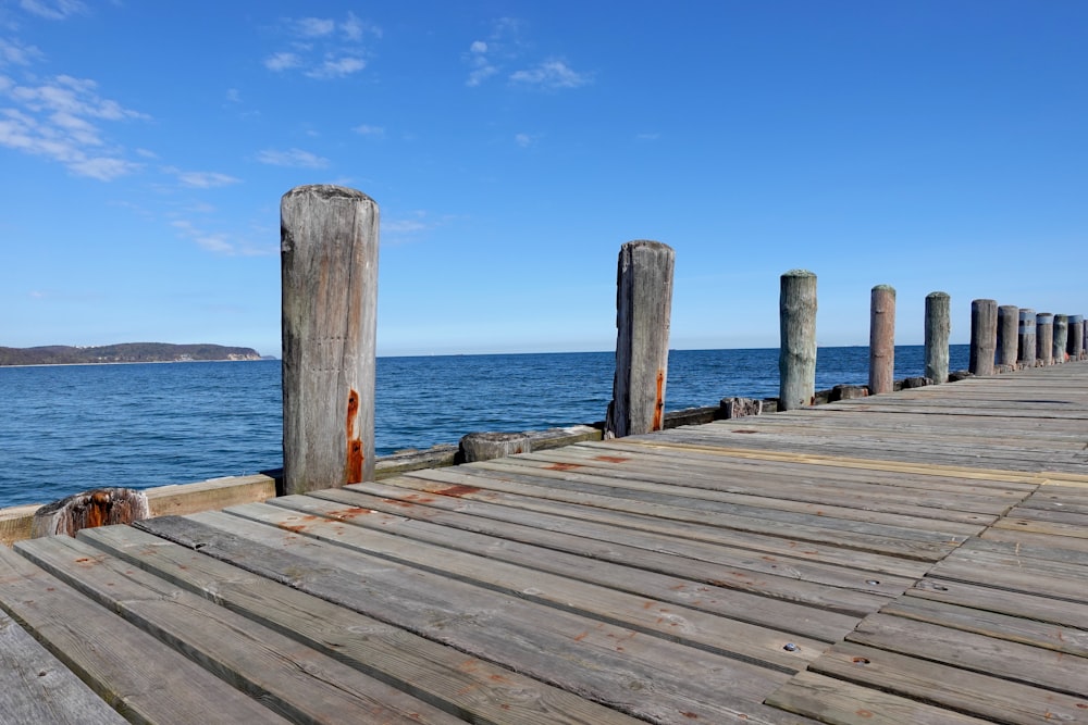 a wood dock leading to a body of water