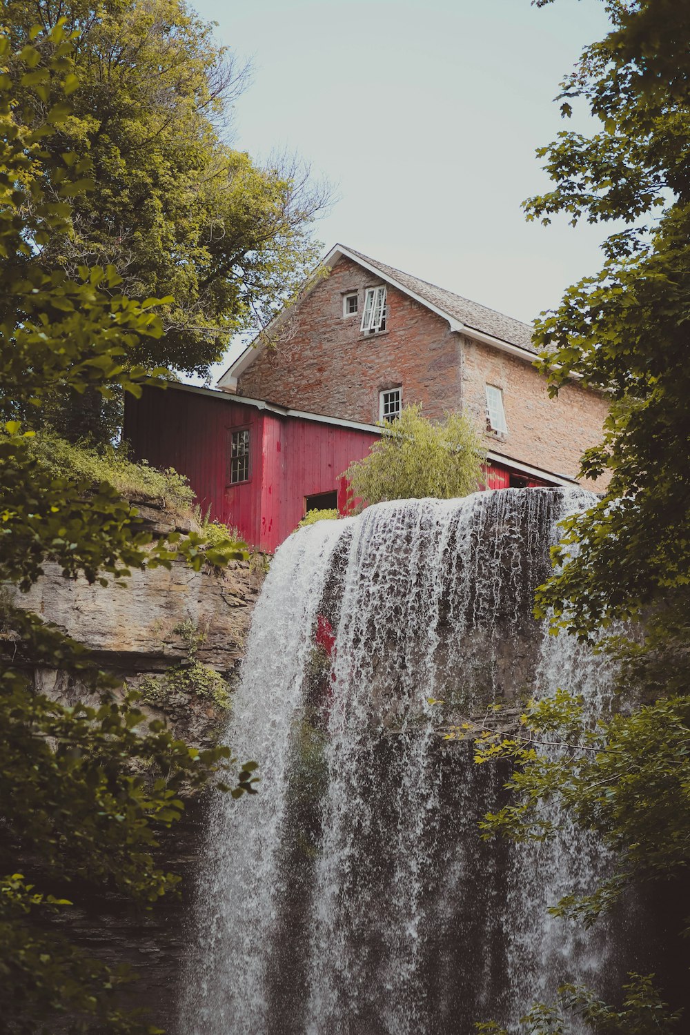 a waterfall in front of a house
