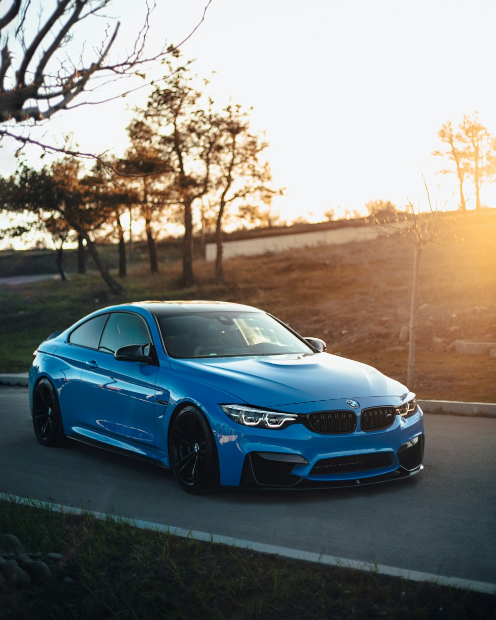 a blue car on a road