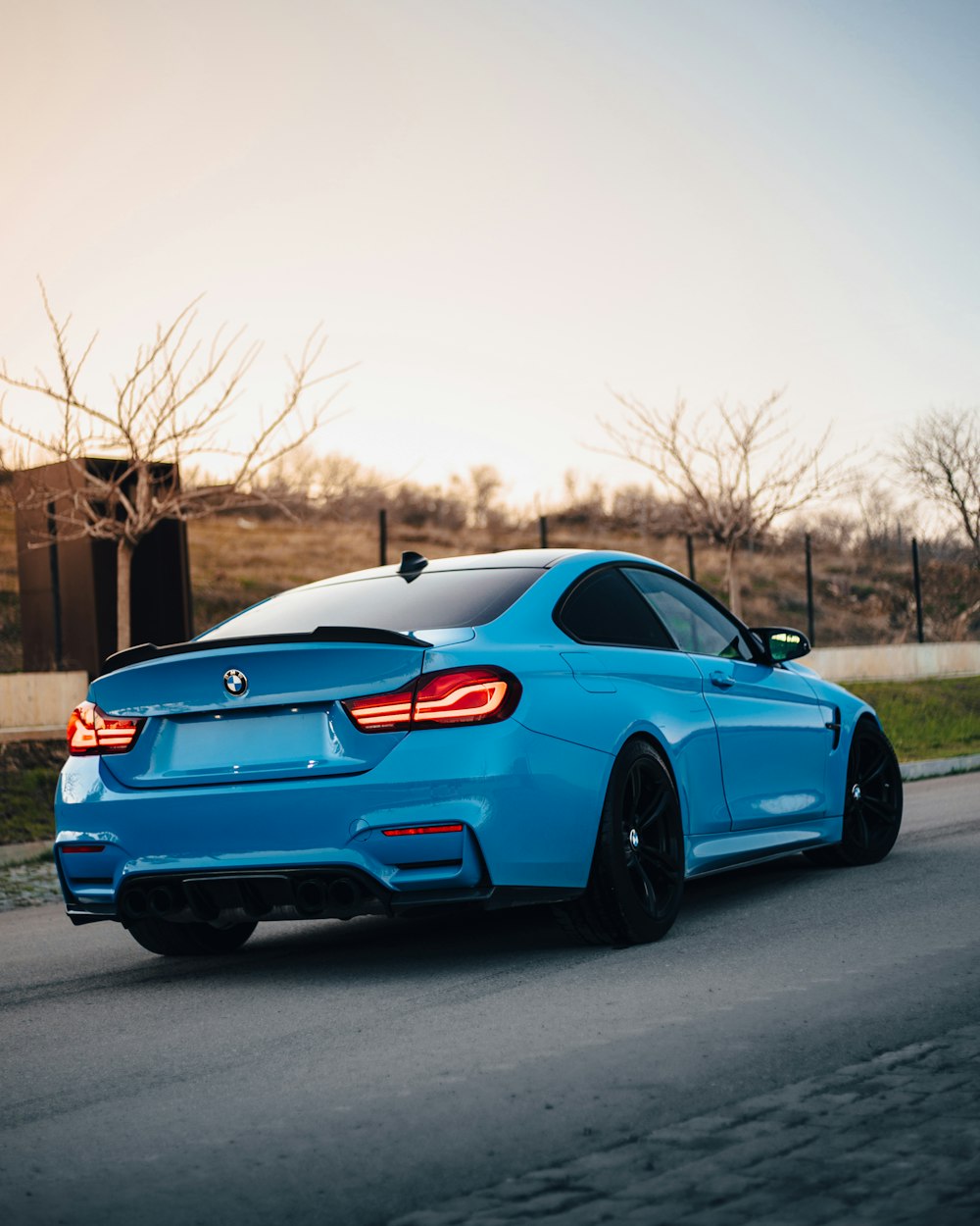 a blue car on a road