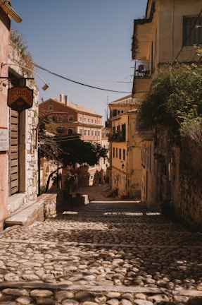 a cobblestone street with buildings on either side of it