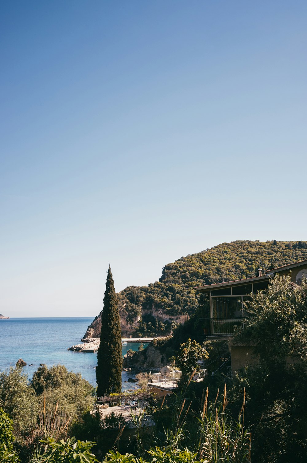 a building on a hill by the water