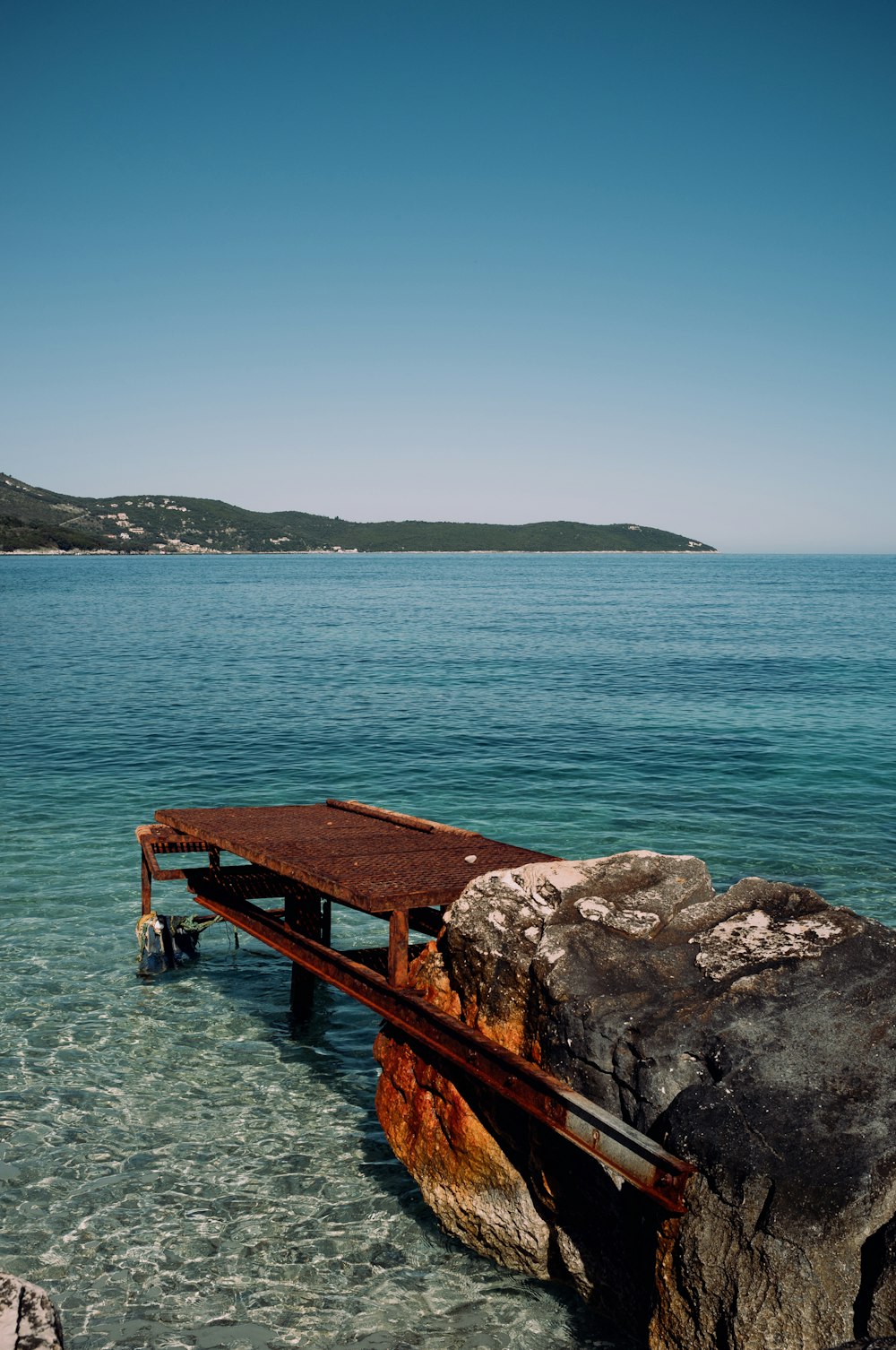 a bench on a rock in the water