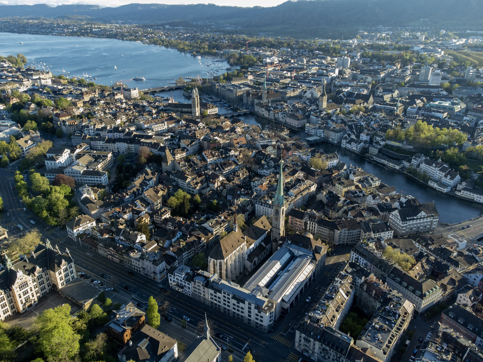 Zurich's historic centre beside Lake Zurich, with the Alps in the distance