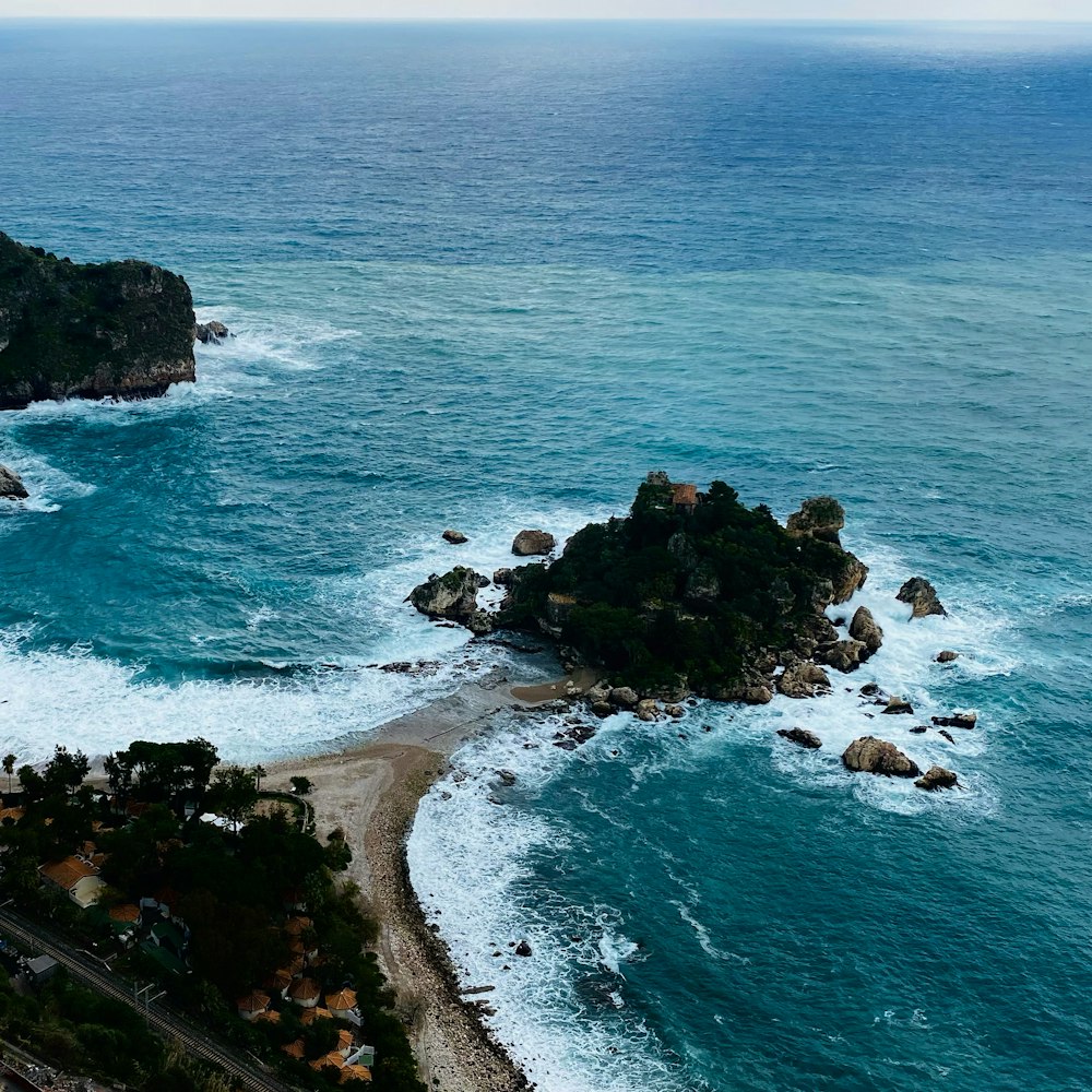 a rocky beach with a body of water in the background with Black Rocks in the background