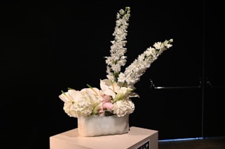 A customer happily receiving a floral arrangement from Delia Florist.