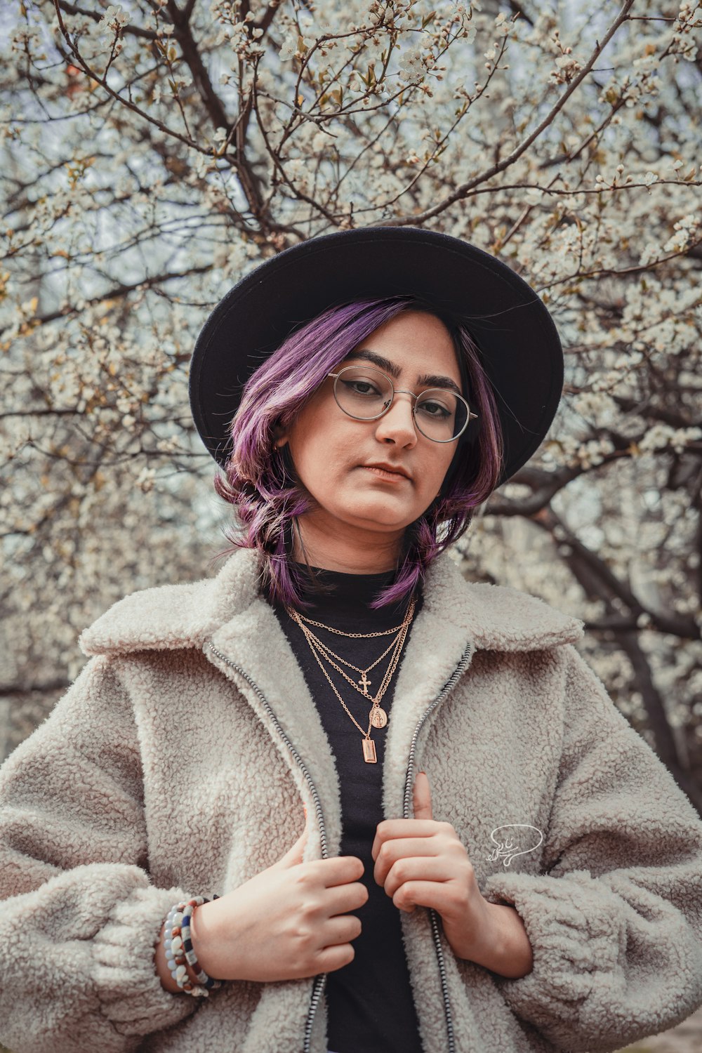 a woman wearing a hat and glasses