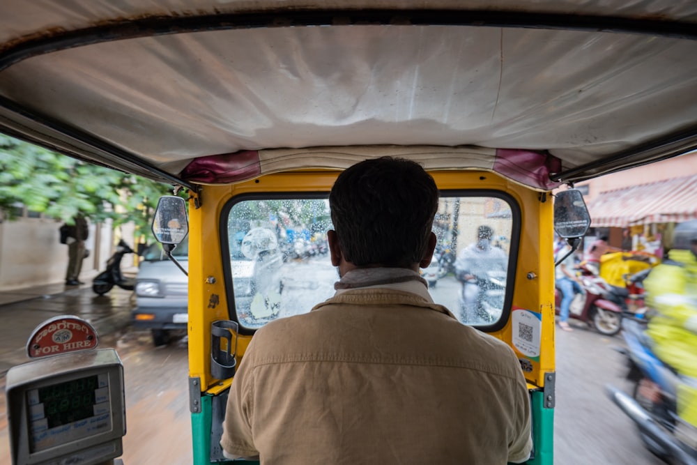 a person in a yellow vehicle