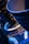 A close-up view of intricate metallic machinery showcasing curved components and structural panels. Bright illumination highlights the textures and details of the surfaces, with a distinct blue and gold color theme giving a futuristic and industrial aesthetic.