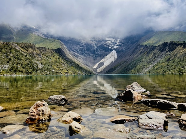 a lake with mountains in the background
