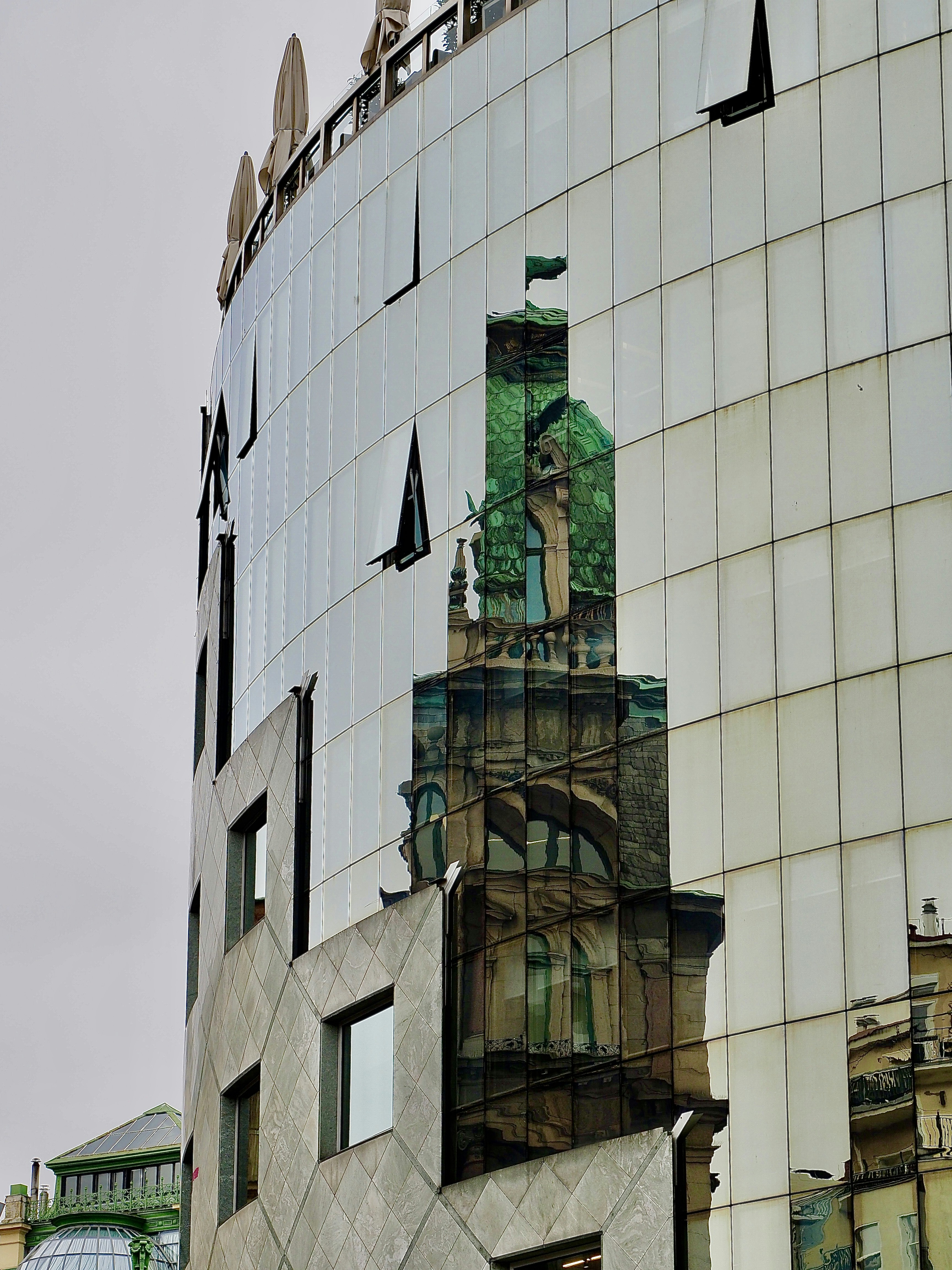 a tall building with a green bell
