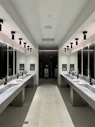a large bathroom with sinks and mirrors