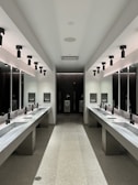 a large bathroom with sinks and mirrors