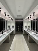 a large bathroom with sinks and mirrors