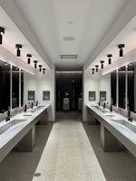 a large bathroom with sinks and mirrors