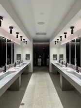 a large bathroom with sinks and mirrors
